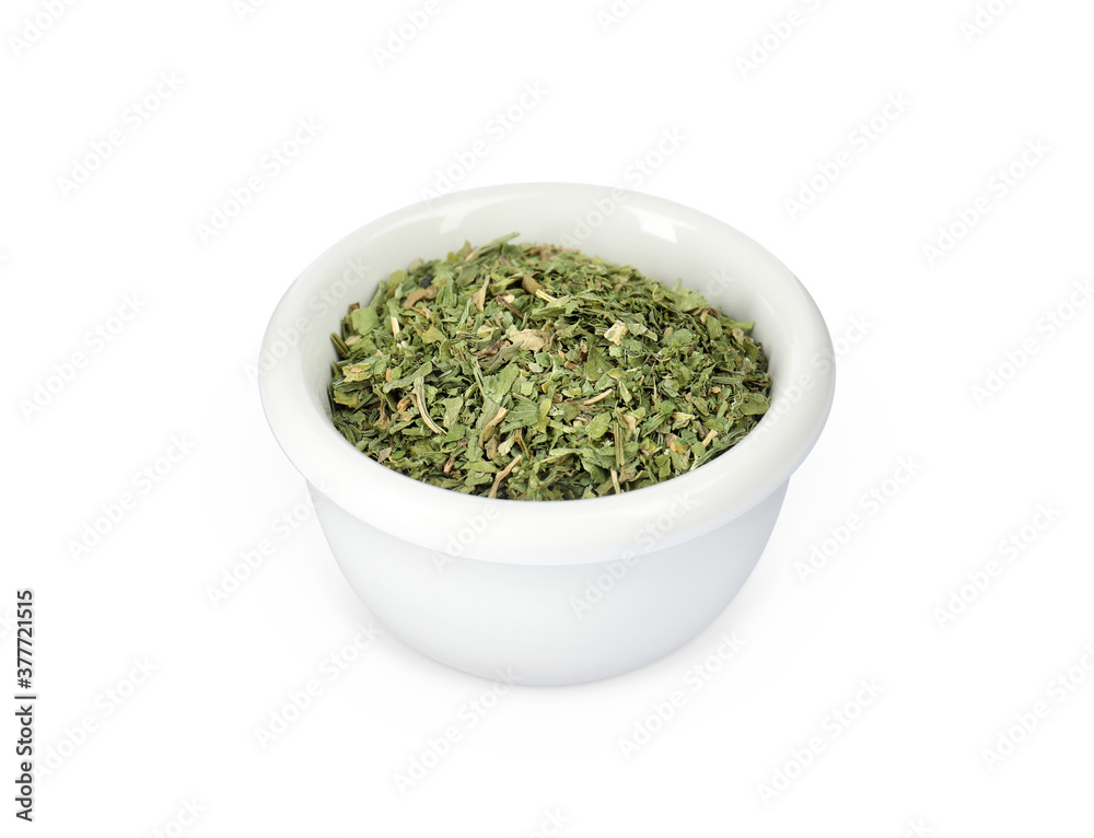 Dry parsley in ceramic bowl on white background Dry parsley in ceramic bowl on white background