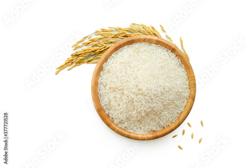 white rice in wooden bowl and paddy rice with rice ear isolated on a white background, top view