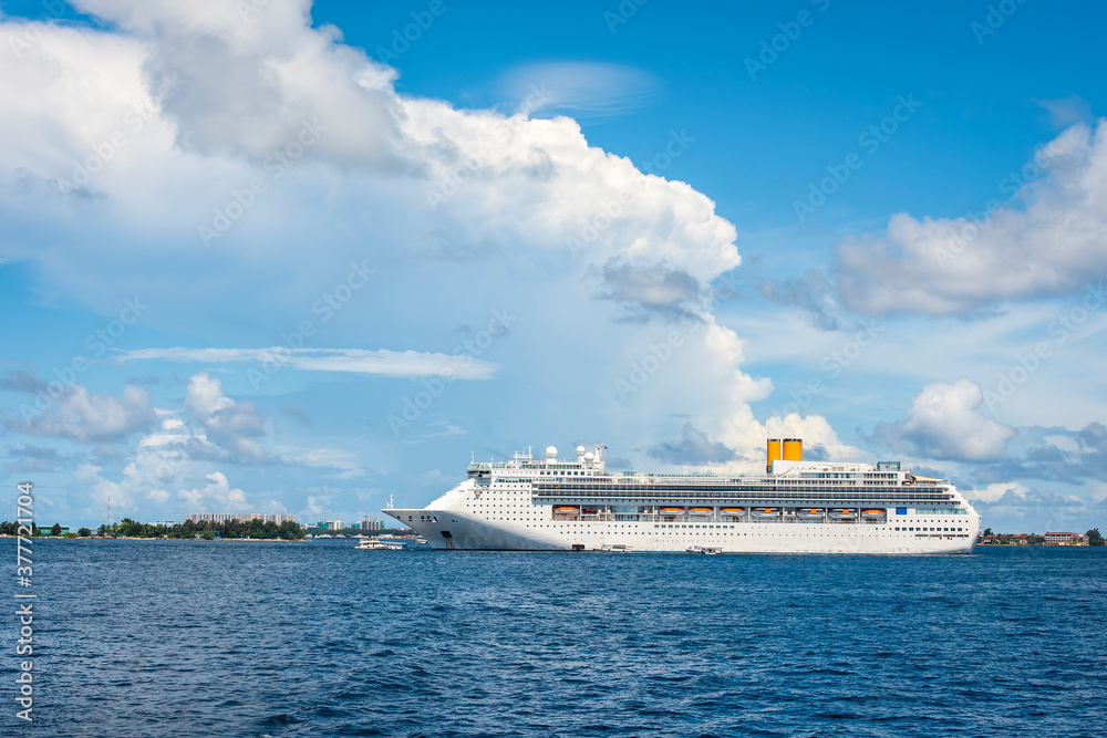 A large white cruise ship near the city of Male in the Indian ocean