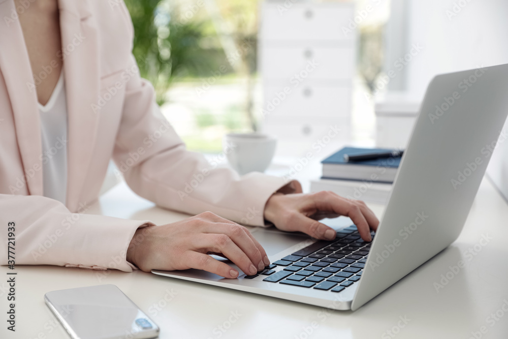 Woman working on laptop at table, closeup Woman working on laptop at table, closeup