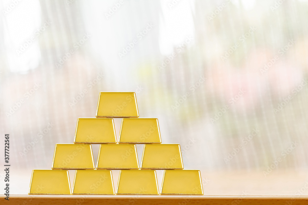 Gold bar with high value for invest put on the desk in the office, Targeting of business to winner and success concept. Gold bar with high value for invest put on the desk in the office, Targeting of business to winner and success concept.