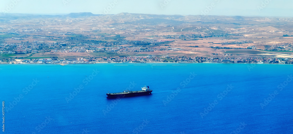 Aerial view of Cyprus island surrounded by azure sea with waves