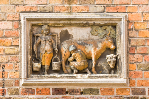 Historic centre of Bruges, bas relief, Huidenvettersplein (milk production), Belgium, Unesco World Heritage Site. photo