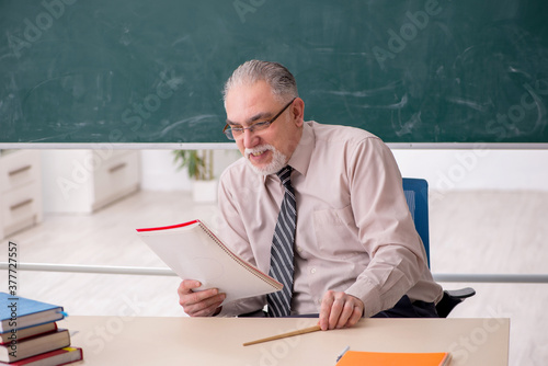 Old male teacher in the classroom