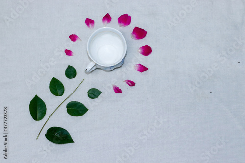 Empty tea and saucer with rose petals