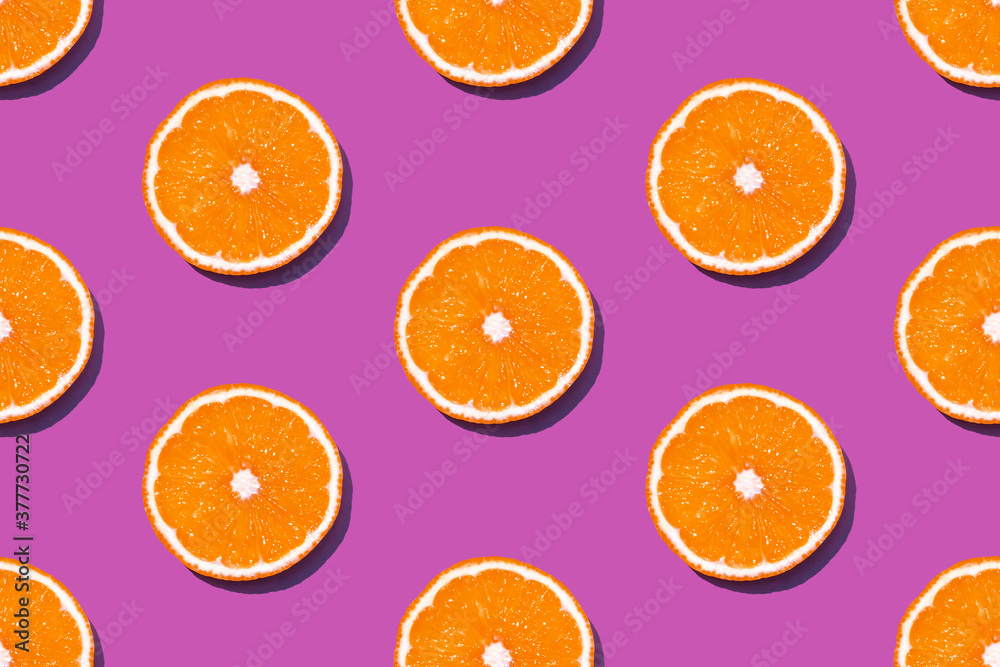 Top view of fresh lemon seamless pattern on pink or fuchsia background. Many sliced yellow lemon seamless texture and lilac background. Fruit minimal concept. Top view of fresh lemon seamless pattern on pink or fuchsia background. Many sliced yellow lemon seamless texture and lilac background. Fruit minimal concept.