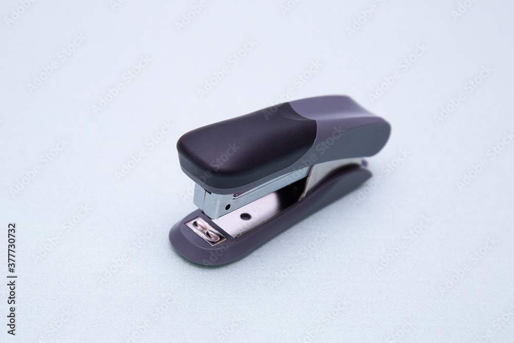 Stapler on a green background. Stationery. Office tool. Stapler on a green background. Stationery. Office tool.
