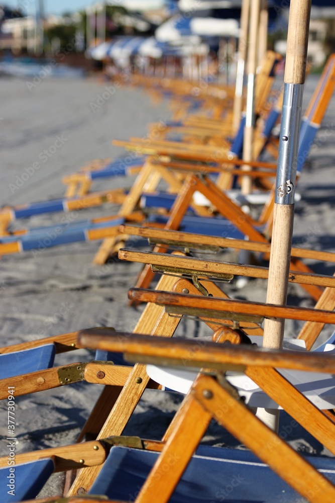 Row of Beach Chairs with Umbrellas Row of Beach Chairs with Umbrellas