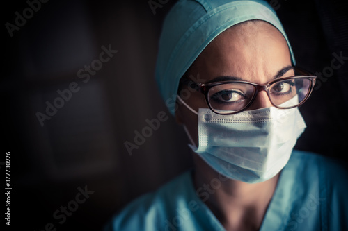Young female medic, wearing a mask and glasses