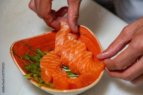 Obraz na płótnie Closeup of chef hands preparing japanese food. Japanese chef making sushi at restaurant. w salonie