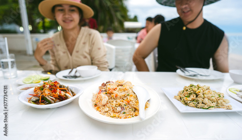 Thai style egg fried rice with on table with people background