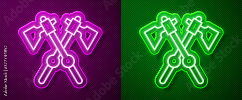 Glowing neon line Crossed medieval axes icon isolated on purple and green background. Battle axe, executioner axe. Medieval weapon. Vector.