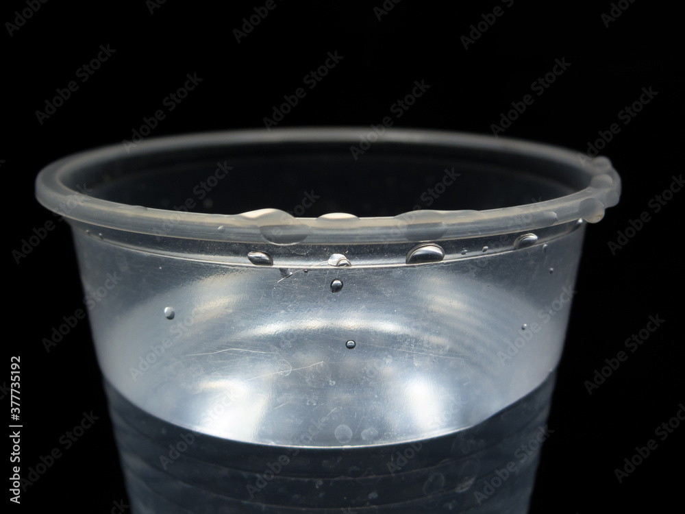Plastic cup with water, dramatic illumination Stock Photo Adobe Stock