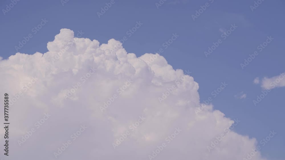 Beautiful Cumulus cloud filling frame against blue sky on Summer day - locked off view Beautiful Cumulus cloud filling frame against blue sky on Summer day - locked off view
