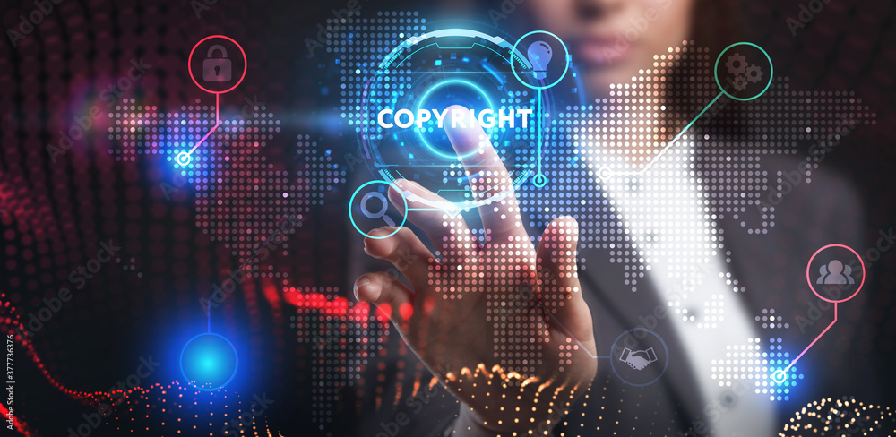 Fototapeta premium Business, Technology, Internet and network concept. Young businessman working on a virtual screen of the future and sees the inscription: Copyright