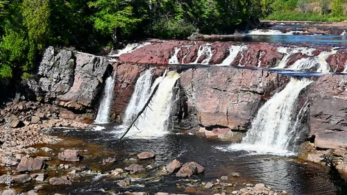 Lepreau Falls in New Brunswick. The water level is very low and the falls a trickle compared to normal. Much of the river bed is visible. Slow motion. photo