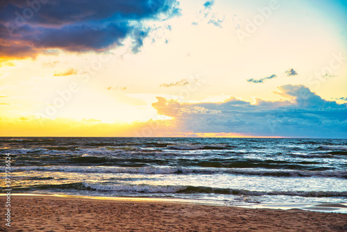 Sunset view over the sea. Beautiful sunset over the sea. View of the beach  sea and sunset.