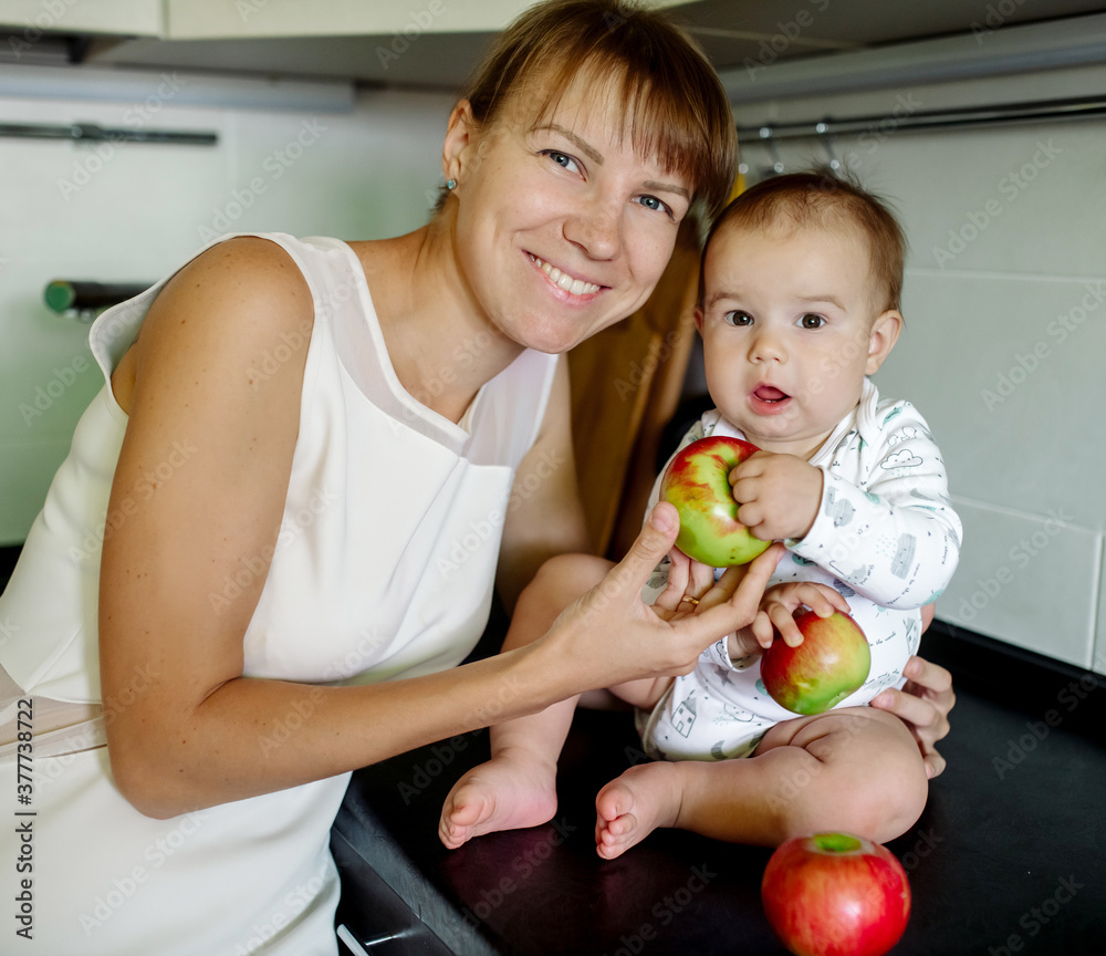Mom and baby in the kitchen eating apples
Mom and baby in the kitchen eating apples