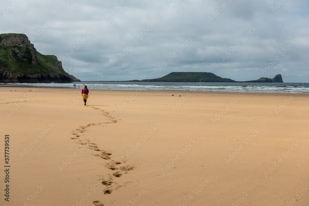 person walking on the beach (rosshili, wales) person walking on the beach (rosshili, wales)