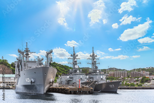 yokosuka, japan - july 19 2020: Wide angle on the japanese Replenishment oiler JS Masyu AOE-425 and the destroyer ships JS Murasame DD-101 and JS Ikazuchi DD-107 berthed in the Yokosuka naval port. photo