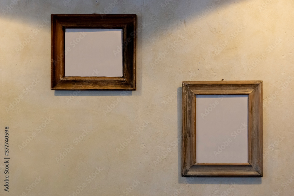empty picture frames on a wall with rough plaster, copy space empty picture frames on a wall with rough plaster, copy space