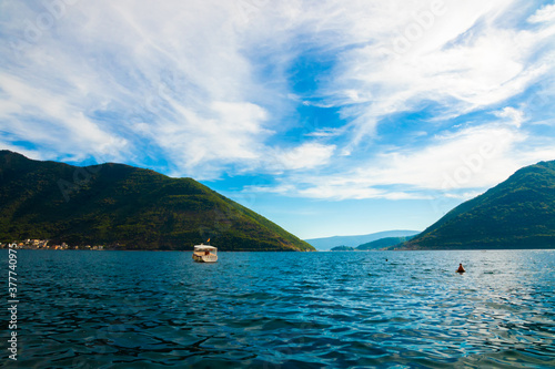 View of the Bay of Kotor from the coast of the old town, boat with the inscription Perast