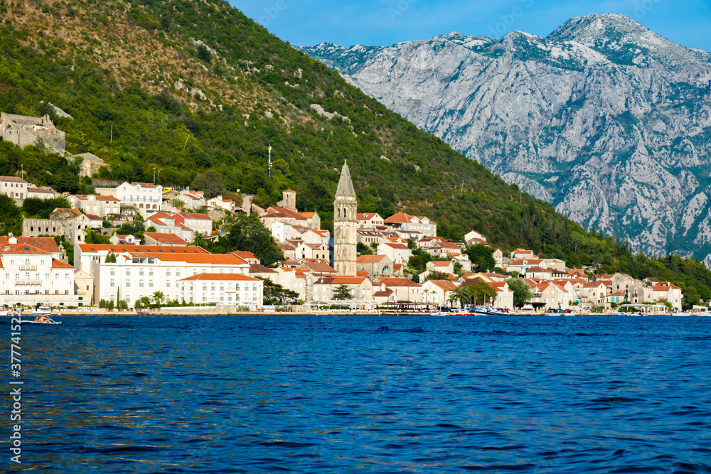 View of the city of Perast from the sea against the backdrop of high green mountains
