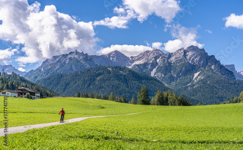 pretty senior woman riding her electric mountainbike in the Prags Dolomites , Tre cime National park, South Tirol, Italy  photo