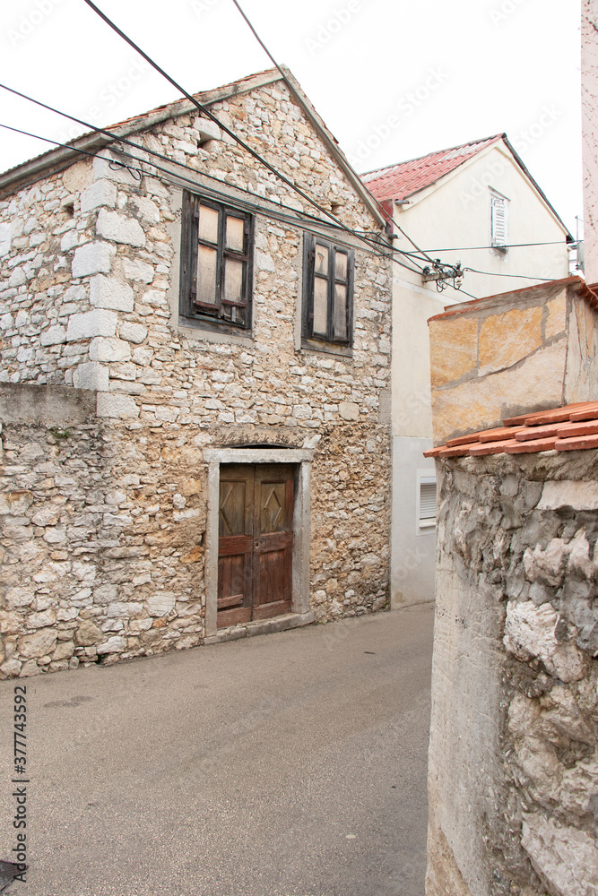 Old abandoned traditional stone house in the town street