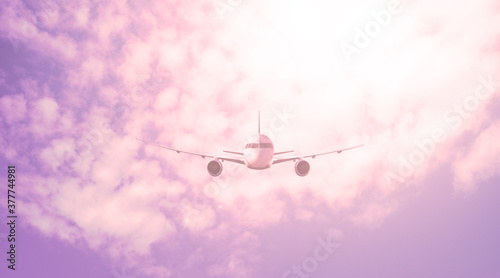 Large plane against the background of a red sky with clouds