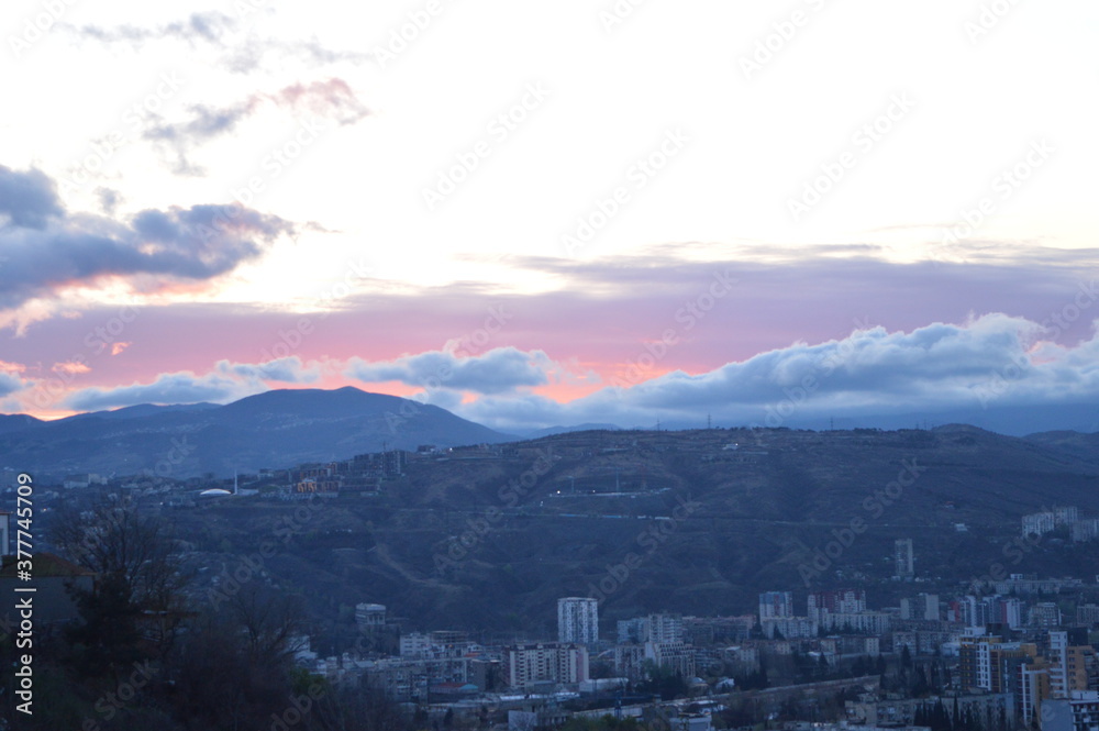 Fototapeta premium Mountain landscape at sunset. Art summer background. Blue sky and white clouds. 