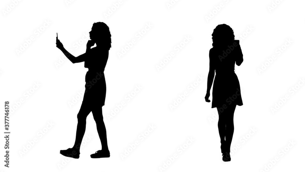Silhouettes of young trendy woman walking and filming video with smart phone. Side and front view isolated on white background. Silhouettes of young trendy woman walking and filming video with smart phone. Side and front view isolated on white background.