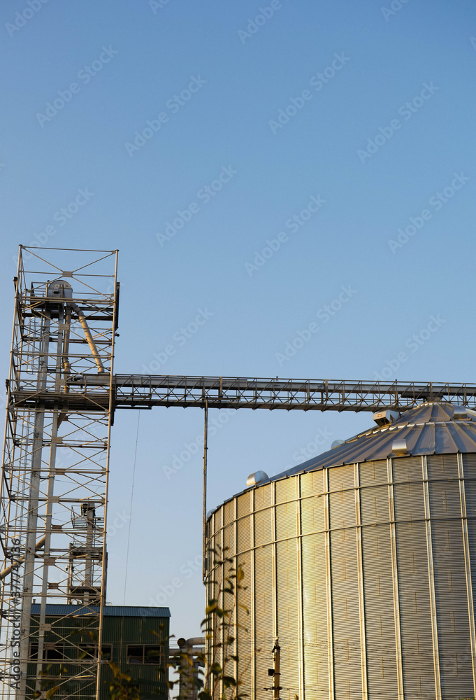 Steel grain elevator close up. Agriculture business. Cereals storage. Vertical orientation 