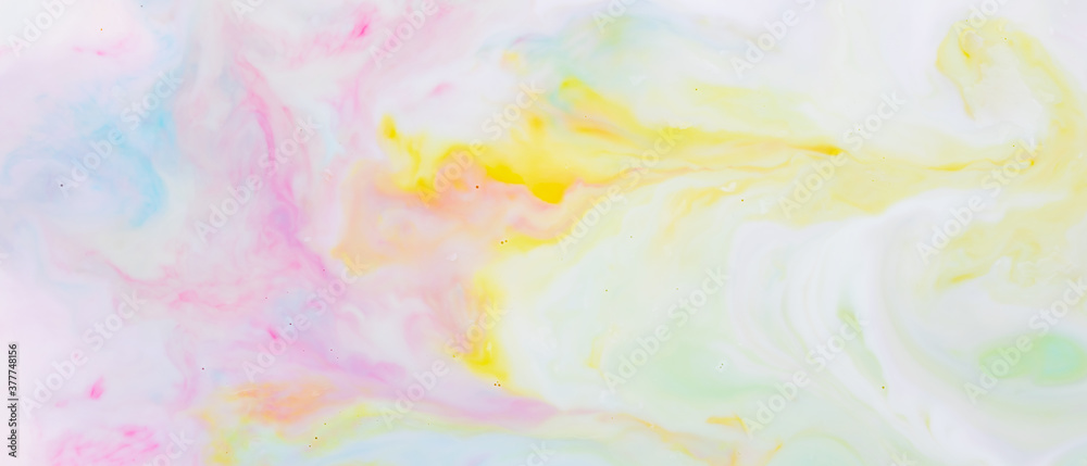 Fluid art. Multicolored background from liquid. Photography of colored spots on liquid. Abstract pattern