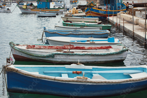 old fisherman village and important tourist attraction on the island. Traditional eyed colorful boats Luzzu in the Harbor of Mediterranean fishing village Marsaxlokk