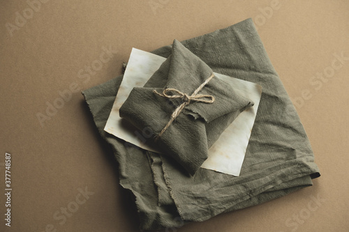 top view gift box wrapped in green cloth on a brown background