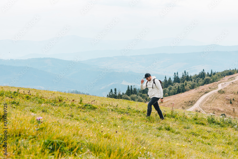 man with backpack hiking in mountains