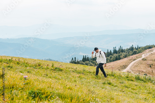 man with backpack hiking in mountains © phpetrunina14
