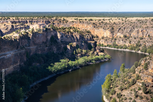 Romanesque church Ermita de San Frutos on top of a hill. Hermitage built in a canyon in the middle of the river Duratón. Dry Spanish landscape. Hoces del Duratón (Duraton gorges), Segovia, Spain