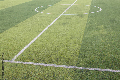 Obraz na płótnie Photo of a green synthetic grass sports field with white line shot from above. w salonie