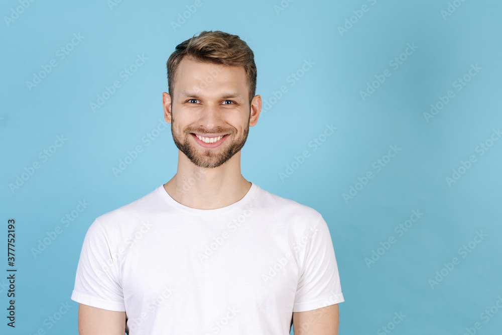 Fototapeta premium Young man standing isolated on blue background