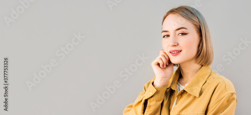Smiling woman satisfied with her nature beauty isolated on gray background