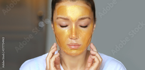 Anti-aging therapy. young woman applying facial mask. woman moisturizing face mask. 