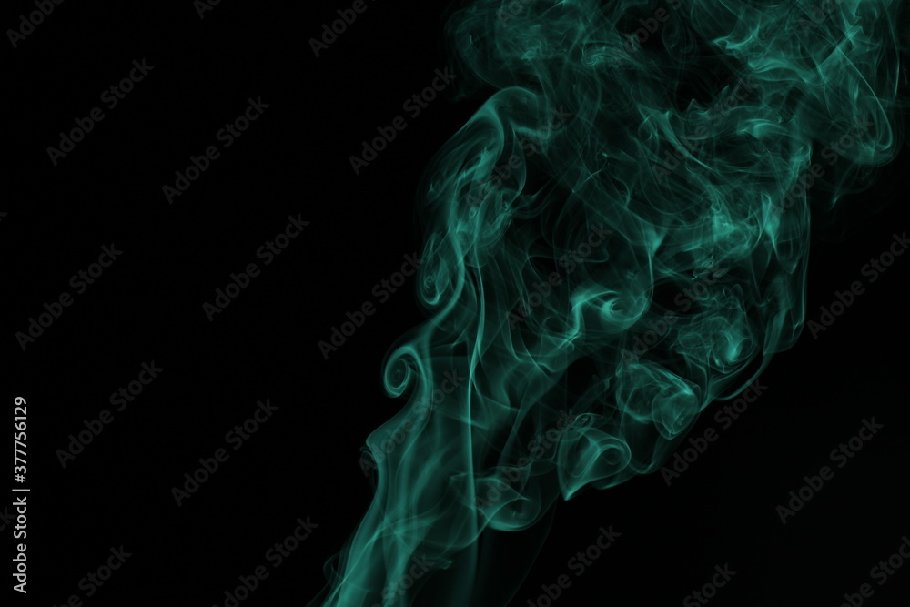 green smoke from incense on a black background green smoke from incense on a black background