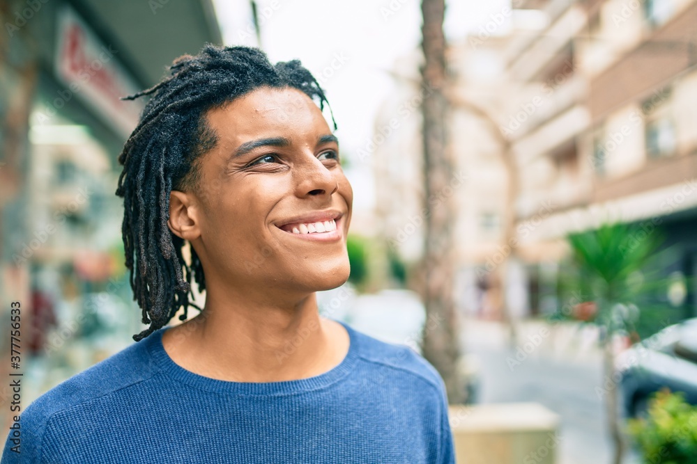 Young african american man smiling happy looking to the side at street of city. Young african american man smiling happy looking to the side at street of city.