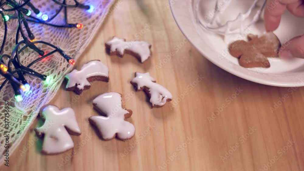 Person decorating gingerbread cookies for Christmas. Person decorating gingerbread cookies for Christmas.