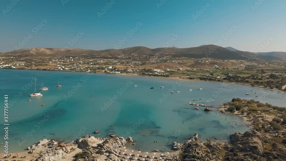Aerial drone video of sandy beach blue sea water, clear blue sky Paros island Cyclades, Greece Aerial drone video of sandy beach blue sea water, clear blue sky Paros island Cyclades, Greece