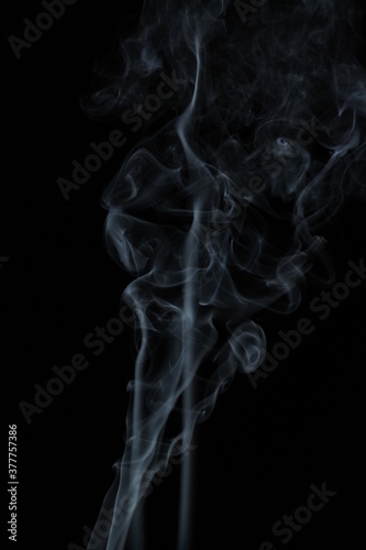 White smoke from incense on a black background