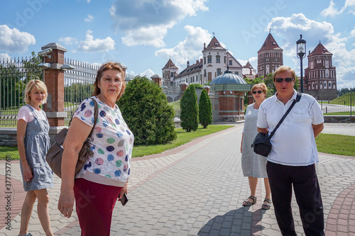 A group of Mature tourists walk in a Park