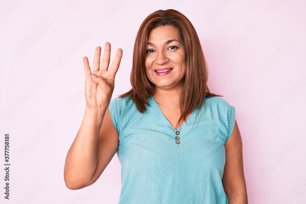 Middle age brunette hispanic woman wearing casual clothes showing and pointing up with fingers number four while smiling confident and happy. Middle age brunette hispanic woman wearing casual clothes showing and pointing up with fingers number four while smiling confident and happy.